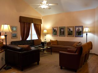 Living room with leather furniture and pictures of English gardens